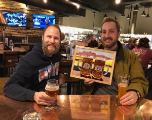 Local beer artist Scott Clendaniel with one of his paintings that 49th State Brewery bought